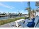 Inviting patio with comfortable seating, a grill, and picturesque waterfront views at 9822 Desoto Ct, Bradenton, FL 34210