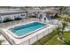 Community pool surrounded by white fencing and lush lawns on a sunny day at 9822 Desoto Ct, Bradenton, FL 34210