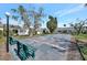 Shuffleboard court with lush landscaping and benches for players to rest at 9822 Desoto Ct, Bradenton, FL 34210