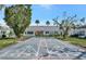 Exterior shot of shuffleboard court with landscaping and benches for players to rest at 9822 Desoto Ct, Bradenton, FL 34210