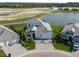 Overhead view showcasing a landscaped home near a lake, part of a residential community at 10030 Degas Ter, Bradenton, FL 34212