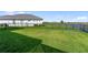 Spacious backyard with lush green lawn and a black metal fence at 10030 Degas Ter, Bradenton, FL 34212