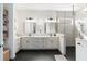 Luxurious bathroom featuring dual sinks, black tile floor, and a glass-enclosed walk-in shower at 10030 Degas Ter, Bradenton, FL 34212