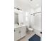 Bright bathroom features a vanity with modern lighting, tile flooring, and a shower/tub combo with white tile surround at 10030 Degas Ter, Bradenton, FL 34212