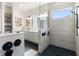 Modern bathroom featuring a walk-in shower, dual sink vanity, and stylish black hardware at 10030 Degas Ter, Bradenton, FL 34212