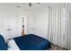 Bedroom with wood floors, ceiling fan, and white curtains with black hardware at 10030 Degas Ter, Bradenton, FL 34212