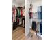 Spacious walk-in closet with ample storage, hanging rods, shelves, and organized clothing at 10030 Degas Ter, Bradenton, FL 34212