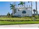 Community entrance sign showcasing colorful landscaping, and tropical foliage at 10030 Degas Ter, Bradenton, FL 34212