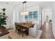 Dining room featuring a wooden table, stylish light fixture, and view to the front entry at 10030 Degas Ter, Bradenton, FL 34212