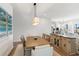 Dining area showcasing a wooden table and proximity to the open living space at 10030 Degas Ter, Bradenton, FL 34212