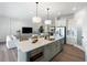 Open-concept kitchen features an island with seating and connects to a comfortable living space at 10030 Degas Ter, Bradenton, FL 34212