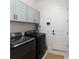 Well-equipped laundry room with modern washer, dryer, and storage cabinets at 10030 Degas Ter, Bradenton, FL 34212