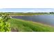 Backyard view of pond with grassy shoreline at 10030 Degas Ter, Bradenton, FL 34212