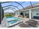 Backyard pool, hot tub, sun loungers, patio seating, and screened-in enclosure at 10030 Degas Ter, Bradenton, FL 34212