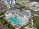 Aerial view of a resort style pool area with cabanas, lounge chairs, and manicured landscaping at 10030 Degas Ter, Bradenton, FL 34212