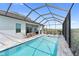 Backyard pool with a built in spa and screened-in enclosure at 10030 Degas Ter, Bradenton, FL 34212