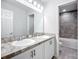 Bathroom featuring double sinks with tiled shower and tub at 1053 Grantham Dr, Sarasota, FL 34234