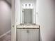 Compact bathroom featuring a vanity with a sink and mirror, complemented by neutral tones and ample lighting at 1053 Grantham Dr, Sarasota, FL 34234
