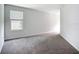 Bedroom features a large window for natural light and plush carpeting for comfort and warmth at 1053 Grantham Dr, Sarasota, FL 34234