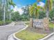 Welcome to Bradford Manor, with stone accented sign surrounded by palm trees, landscape and welcoming entrance at 1053 Grantham Dr, Sarasota, FL 34234
