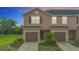Charming townhome featuring a well-maintained lawn, garage, and inviting curb appeal at 1053 Grantham Dr, Sarasota, FL 34234