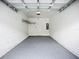 Clean garage with finished epoxy floor and modern lighting, perfect for storage at 1053 Grantham Dr, Sarasota, FL 34234