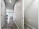 Hallway view with tile flooring flows to an open floor plan, offering seamless connectivity and modern living at 1053 Grantham Dr, Sarasota, FL 34234