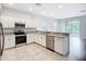 Modern kitchen featuring stainless steel appliances, white cabinets, and an open design at 1053 Grantham Dr, Sarasota, FL 34234