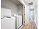 Laundry room with washer, dryer, and wire shelving, convenient for laundry needs at 1053 Grantham Dr, Sarasota, FL 34234