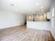 Open concept living room showcasing wood-look flooring and a half wall to the kitchen at 1053 Grantham Dr, Sarasota, FL 34234