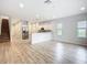 Bright, open-concept floor plan features kitchen with stainless appliances, modern floors and easy access to the staircase at 1053 Grantham Dr, Sarasota, FL 34234