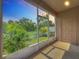 Relaxing screened lanai with a view of lush greenery, offering a serene outdoor space at 1053 Grantham Dr, Sarasota, FL 34234