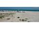 A serene beach with rows of lounge chairs for residents at 1100 Benjamin Franklin Dr # 802, Sarasota, FL 34236