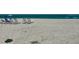 A serene beach with lounge chairs is the perfect spot for a relaxing vacation at 1100 Benjamin Franklin Dr # 802, Sarasota, FL 34236