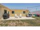 Patio features seating and a grill, perfect for outdoor entertaining in the backyard at 1190 Jamaica Rd, Venice, FL 34293