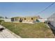 Spacious backyard with patio, screened enclosure, and well-maintained lawn at 1190 Jamaica Rd, Venice, FL 34293