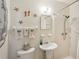 Charming bathroom with nautical decor, a shower with grab bars, and a pedestal sink at 1190 Jamaica Rd, Venice, FL 34293