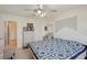 Cozy bedroom featuring light walls, a patterned quilt, and wicker storage furniture at 1190 Jamaica Rd, Venice, FL 34293