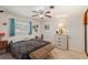 Cozy bedroom with neutral tones, a ceiling fan, and wicker drawers for ample storage space at 1190 Jamaica Rd, Venice, FL 34293