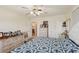 Bright bedroom with light walls, a ceiling fan, and a window for natural light at 1190 Jamaica Rd, Venice, FL 34293