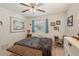 Comfortable bedroom featuring soft lighting, a ceiling fan, and charming decor accents at 1190 Jamaica Rd, Venice, FL 34293