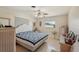 Comfortable bedroom with a white and blue quilt, wicker furniture, and a ceiling fan at 1190 Jamaica Rd, Venice, FL 34293