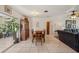 Dining area with tile floors, a wooden table, and a view to the living room at 1190 Jamaica Rd, Venice, FL 34293