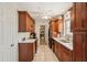 Modern kitchen featuring brown cabinets, white countertops, and stainless steel appliances at 1190 Jamaica Rd, Venice, FL 34293