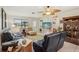 Bright living room with tile and hardwood floors, ceiling fan, and comfortable seating at 1190 Jamaica Rd, Venice, FL 34293