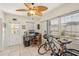 Bright office space with tile floors, a ceiling fan, desk, and windows overlooking the yard at 1190 Jamaica Rd, Venice, FL 34293