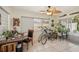Bright sun room with tile flooring, a desk, and sliding glass doors that bring the outside in at 1190 Jamaica Rd, Venice, FL 34293