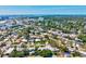 An elevated perspective of a community with a mix of homes, green spaces, and distant waterfront views at 1324 Augusta S Ln, St Petersburg, FL 33707