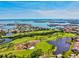 An aerial view of a golf course community with waterfront access and scenic views at 1324 Augusta S Ln, St Petersburg, FL 33707