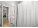 Charming bathroom with a pink sink, gray tile, and a decorative shower curtain at 1324 Augusta S Ln, St Petersburg, FL 33707